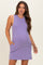 woman wearing a lavender sleeveless maternity dress with pockets and a visible baby bump