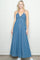 woman wearing a long denim maxi dress with spaghetti straps and a drawstring detail at the bust