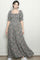 woman wearing a floral maxi dress with puff sleeves and a square neckline, standing against a neutral background