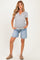 woman wearing a striped maternity t-shirt and denim shorts, with her hands in the pockets and long hair down