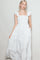 woman wearing a white floral print maxi dress with ruffle sleeves and front buttons