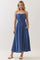 woman wearing a blue maxi dress with adjustable straps and a drawstring waist, featuring pockets and a flowy silhouette