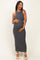 woman wearing a navy and white striped maternity maxi dress, gently holding her baby bump