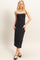 woman wearing a black midi dress with white straps and styled with black flats