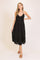 woman wearing a black tiered maxi dress with a halter neck and sandals
