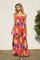 woman wearing a colorful floral maxi dress with a halter neckline and flowing silhouette