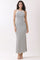 woman wearing a white and black striped maxi dress with a side slit and a fitted silhouette