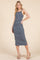 woman wearing a navy and white striped midi dress with side slits and spaghetti straps