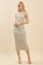woman wearing a beige striped midi dress with thin straps and a side slit