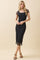 woman wearing a black midi dress with short sheer sleeves and floral patterns