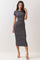 woman wearing a black and white striped midi dress with short sleeves and a fitted silhouette