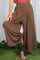 woman wearing brown wide-leg pants with a relaxed fit and an elastic waistband.
