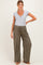 woman wearing a grey short sleeve maternity top and olive green wide-leg pants