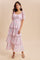 woman wearing a pink floral tiered maxi dress with puff sleeves and square neckline