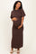 woman wearing a brown short sleeve maternity dress with a fitted silhouette and a visible baby bump
