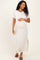 woman wearing a striped maternity maxi dress with short sleeves and a side slit, gently holding her baby bump
