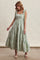 woman wearing a green and white striped maxi dress with tie straps and tiered skirt