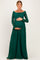 woman wearing a dark green lace maternity gown with long sleeves and a visible baby bump