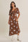 woman wearing a brown floral midi dress with a tie front and short flutter sleeves