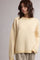 woman wearing a cozy yellow and white striped oversized sweater with a relaxed fit