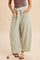 woman wearing green and white gingham wide-leg pants with a drawstring waist and pockets