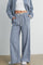woman wearing blue and white checked wide-leg pants with drawstring waist and pockets