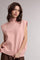woman wearing a light pink sleeveless mock neck top with a relaxed fit