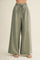 woman wearing light olive green wide-leg pants with an elastic waistband and drawstring detail