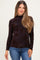 woman wearing a black long sleeve maternity top with floral design and a mock neckline