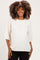 woman wearing a cream oversized maternity sweater with short sleeves and a relaxed fit, smiling and showing her baby bump