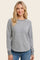 woman wearing a gray long sleeve sweatshirt with a round neckline and raglan sleeves