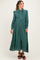 woman wearing a green maternity dress with a button-up front and ruffled hem, styled with a tie waist and long sleeves