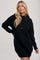 woman wearing a black knitted hoodie dress with a relaxed fit and drawstring details