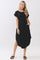 woman wearing a black short sleeve loose fit dress with pockets and side slits, styled with black sandals