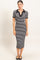 woman wearing a black and white striped midi dress with a polo collar and short sleeves