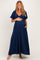 woman wearing a navy blue maxi maternity dress with short flutter sleeves and a baby bump visible