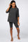 woman wearing charcoal grey oversized pocket tee and matching biker shorts lounge set
