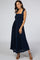 woman wearing a navy blue maxi dress with smocked bodice and tie shoulder straps