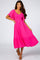 woman wearing a bright pink tiered midi dress with flutter sleeves and a smocked bodice