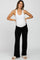 woman wearing a white tank top and black maternity pants, showcasing her baby bump