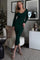 woman wearing a dark green ribbed midi dress with long sleeves and a scoop neckline, posing indoors
