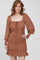 woman wearing a brown and orange floral printed mini dress with long puff sleeves and a ruffled hem