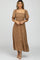 woman wearing a brown floral smocked midi dress with flutter sleeves and square neckline