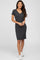 woman wearing a black short sleeve v-neck floral print knee length dress and white sneakers