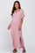 smiling woman wearing a mauve short sleeve button down maternity maxi dress with side slits