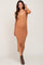 pregnant woman wearing a camel ribbed button down maternity midi dress and brown boots