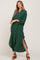woman wearing a long sleeve forest green button down maxi shirt dress with side slits and brown heels