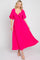 Woman wearing a hot pink swiss dot midi dress with flutter sleeves and a tie-front bodice