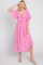 woman wearing a pink flutter sleeve maxi dress with a front knot detail