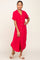 Woman wearing a bright pink short-sleeve button-down midi shirt dress with woven slide sandals